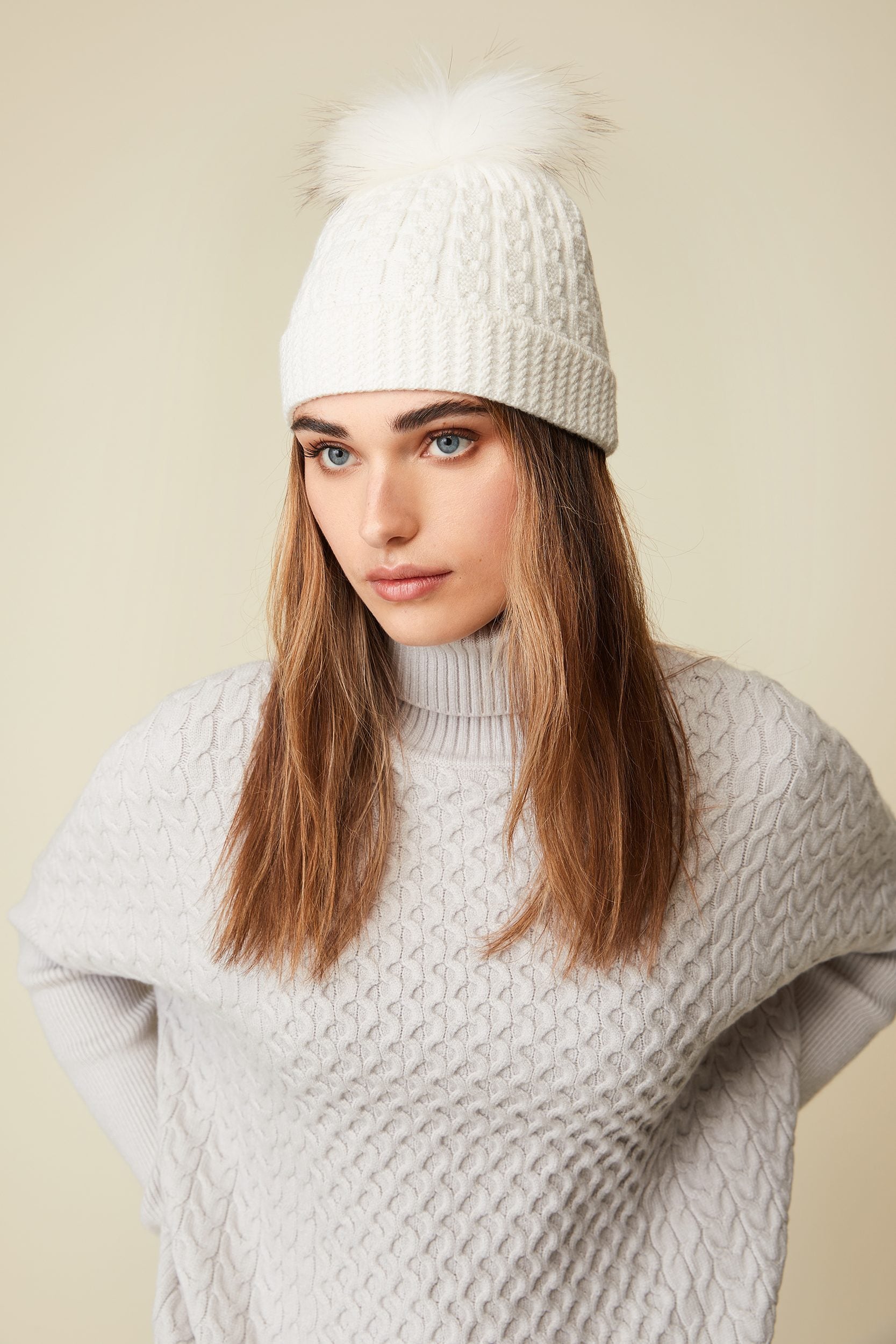 Cable hat with fur pompom