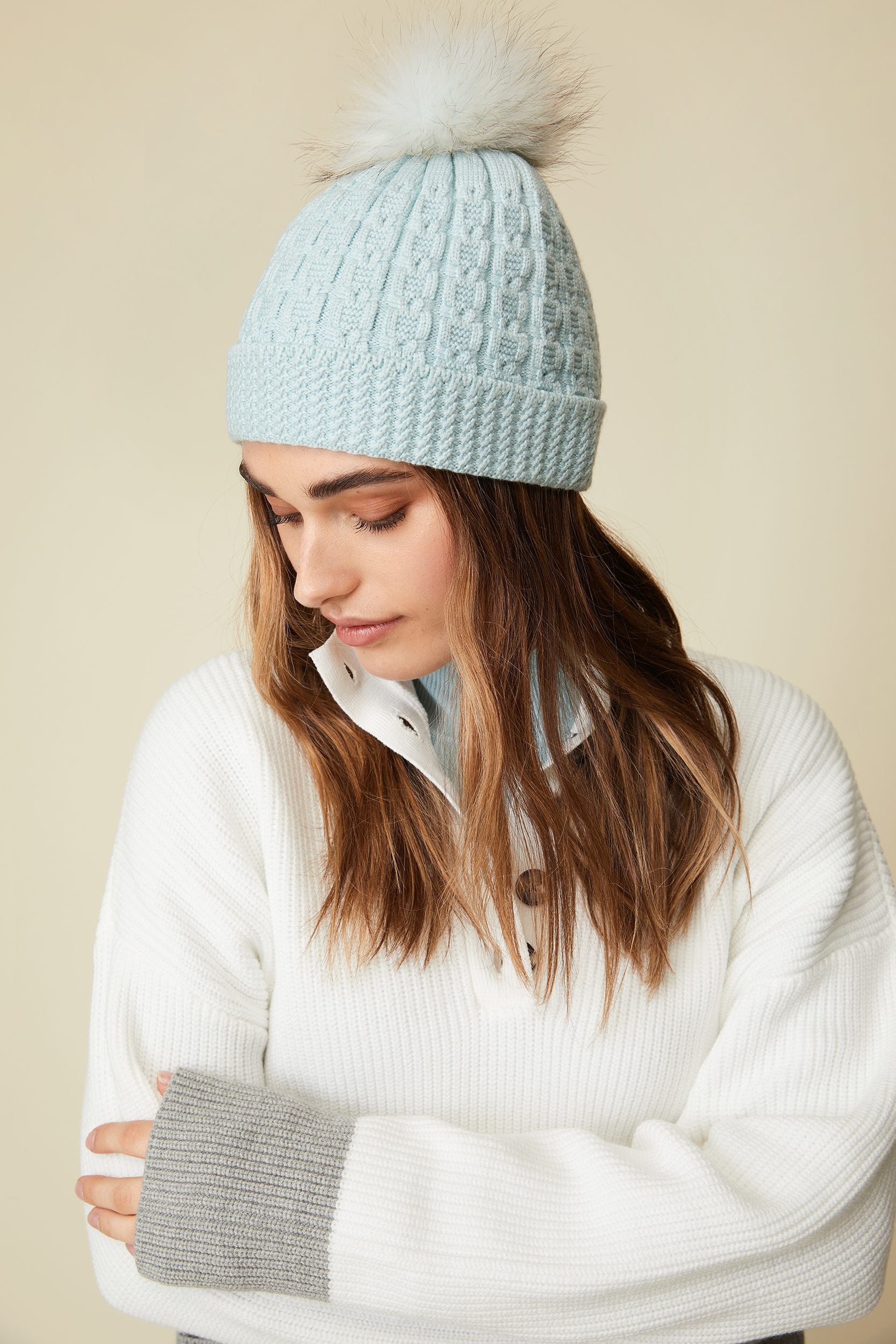 Cable hat with fur pompom