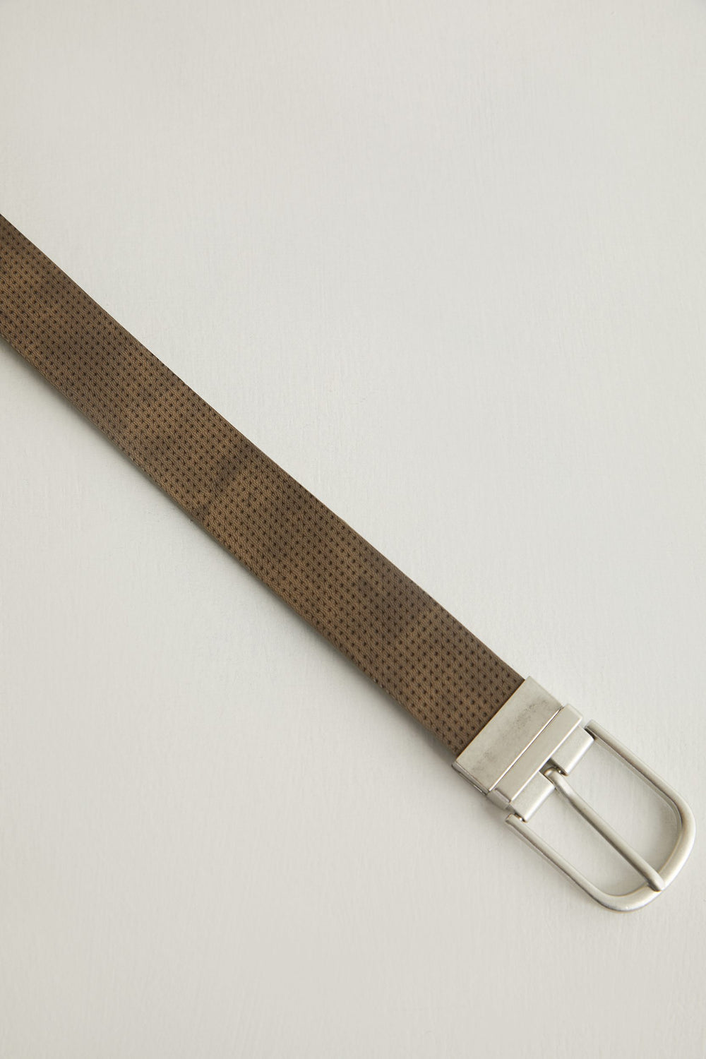 Perforated reversible belt